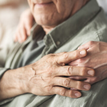 Comforting hand supporting the old man