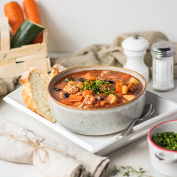 Traditional Italian Chicken Stew Stew Soup in bright vibrant kitchen setting with food styling look