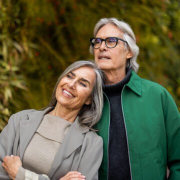 Mature couple smiling, embracing, and enjoying nature together